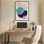 Minimalist abstract hand-painted canvas with layered geometric circles in teal, navy, pink and cream tones, modern workspace