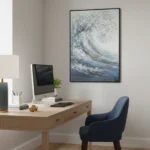 Textured abstract hand-painted canvas depicting rolling ocean wave in layered blues and whites, modern office setting