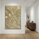 Textured abstract hand-painted canvas with radiating linear patterns in warm cream and gold tones, contemporary hallway setting