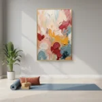 Gestural abstract hand-painted canvas in layered coral, crimson, gold and slate tones, yoga studio setting