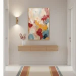 Gestural abstract hand-painted canvas with layered floral forms in coral, gold, and blue tones, contemporary entryway