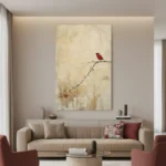 Minimalist hand-painted canvas featuring a solitary red cardinal perched on a delicate branch, cream and muted earth tones, contemporary living space