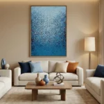 Textured abstract hand-painted canvas in layered blue and white brushstrokes, contemporary living space