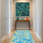 Gestural abstract expressionist hand-painted canvas in layered teals, yellows, and navy with dynamic brushstrokes, contemporary entryway