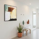 Gestural abstract painting in warm ochre, deep brown, and cream with layered brushwork, contemporary entryway
