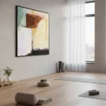 Gestural abstract hand-painted canvas with layered browns, creams, and muted greens, yoga studio setting