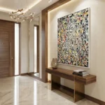 Abstract expressionist hand-painted canvas with dynamic black, yellow, and red gestural marks, modern entryway