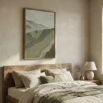 Textured landscape painting depicting rolling hills and mountains in muted greens and grays, hand-painted canvas in modern bedroom