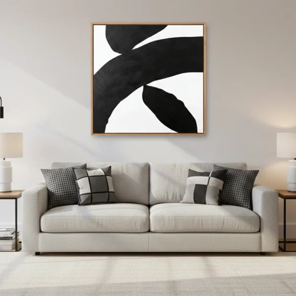 Minimalist abstract hand-painted canvas in bold black and white organic shapes, contemporary living space