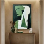 Contemporary abstract hand-painted canvas in layered greens, whites and charcoal with gestural brushstrokes, modern entryway
