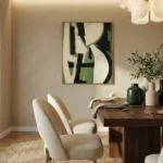 Contemporary abstract hand-painted canvas in cream, black and sage green geometric forms, dining space setting