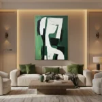Abstract hand-painted canvas with gestural white and black forms on rich green background, contemporary living space