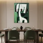 Contemporary abstract hand-painted canvas in forest green and cream with gestural black forms, dining space
