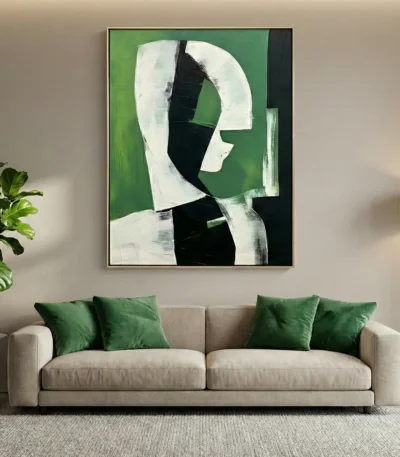 Minimalist hand-painted canvas featuring abstract profile silhouette in white and black against layered green background, contemporary living space