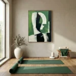Abstract expressionist hand-painted canvas in forest green, black and cream with gestural brushwork, yoga studio setting