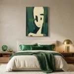 Minimalist figurative hand-painted canvas with cream and black face against layered green tones, modern bedroom setting