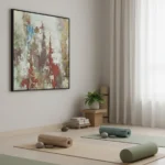 Textured abstract hand-painted canvas in layered reds, blues, and earth tones with weathered brushwork, yoga studio setting