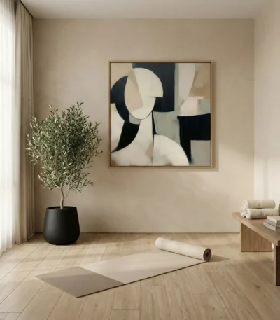 Contemporary abstract hand-painted canvas with geometric shapes in black, cream, and taupe tones, yoga studio setting
