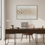 Textured abstract hand-painted canvas in cream and gold leaf with floating botanical forms, contemporary office space