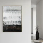 Layered abstract hand-painted canvas depicting misty forest landscape in monochrome grays and blacks, contemporary hallway setting