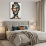 Gestural expressionist hand-painted canvas depicting a colorful abstracted portrait in vibrant multi-hued brushstrokes, contemporary bedroom setting