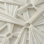 Textured abstract hand-painted canvas with gathered cream fabric folds and dimensional relief, monochromatic ivory tones