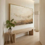 Contemporary landscape hand-painted canvas in warm earth tones and soft cream, minimal interior setting