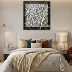 Gestural abstract hand-painted canvas with interlocking white and gold brushstrokes on black, contemporary bedroom
