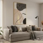 Layered abstract hand-painted canvas featuring organic shapes in charcoal, cream, and gold leaf accents, contemporary living space