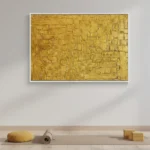 Textured abstract hand-painted canvas in layered golden tones with geometric rectangular patterns, contemporary living space