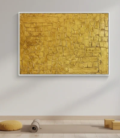 Textured abstract hand-painted canvas in layered golden tones with geometric rectangular patterns, contemporary living space