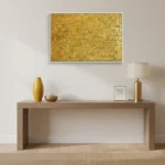 Textured abstract hand-painted canvas in layered golden ochre and cream tones, contemporary entryway setting