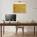 Textured abstract hand-painted canvas in rich golden yellows and ochre tones, contemporary office space
