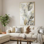 Contemporary hand-painted canvas of layered feathers in soft gray, cream, and gold tones, modern living space