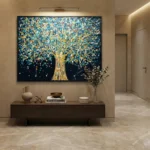 Gestural abstract hand-painted canvas depicting a luminous tree with gold trunk and turquoise foliage against deep navy background, contemporary entryway