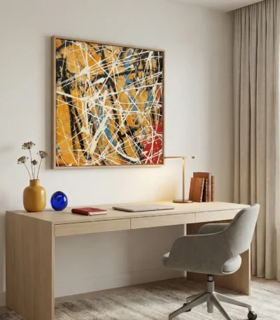 Gestural abstract expressionist hand-painted canvas in bold yellows, blues, and reds with dynamic white brushstrokes, contemporary workspace