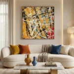 Gestural abstract expressionist hand-painted canvas in golden ochre, cream, navy and black with dynamic white brushstrokes, contemporary living space