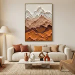 Textured landscape hand-painted canvas depicting layered mountains in cream, terracotta, and ochre tones, contemporary living space