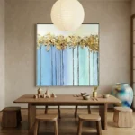 Contemporary hand-painted canvas depicting golden trees against layered blue sky gradient, minimalist aesthetic
