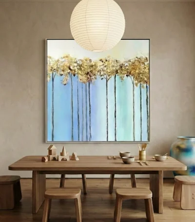 Contemporary hand-painted canvas depicting golden trees against layered blue sky gradient, minimalist aesthetic