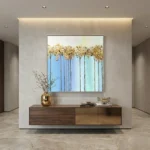 Contemporary abstract wall art depicting tall trees with golden foliage against blue gradient sky, hand-painted canvas in modern interior