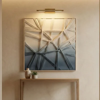 Layered abstract hand-painted canvas with sweeping gestural brushstrokes in cream, charcoal, and slate blue tones, contemporary entryway