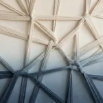 Textured abstract hand-painted canvas with interwoven cream and charcoal ribbons creating dimensional geometric patterns