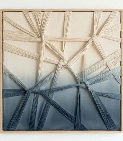 Textured abstract hand-painted canvas with interwoven natural fiber strands in cream, sage, and deep navy gradient, contemporary white room