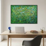 Gestural abstract expressionist hand-painted canvas in vibrant greens, blues and yellows with dynamic layered brushstrokes, modern office setting