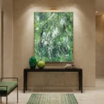 Gestural abstract hand-painted canvas in layered greens and whites with dynamic line work, contemporary entryway setting