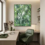 Abstract expressionist hand-painted canvas in layered greens and whites with gestural brushstrokes, modern office workspace