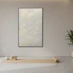 Textured minimalist hand-painted canvas with organic petal forms in cream and gold leaf, contemporary studio setting