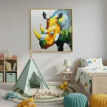 Contemporary hand-painted canvas depicting a vibrant geometric rhino in yellow, orange and blue tones, children's room