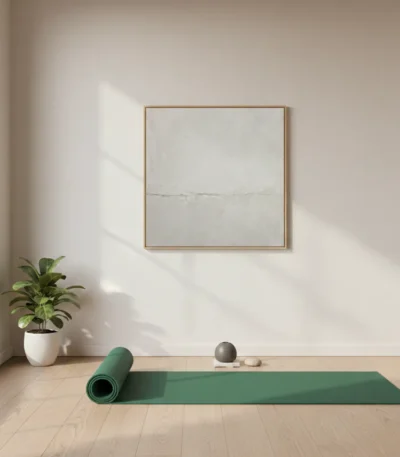 Minimalist abstract hand-painted canvas in soft cream and grey tones with subtle horizontal division, yoga studio setting